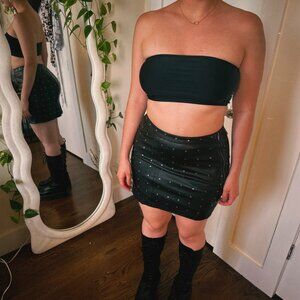 Tight black leather mini skirt with trux